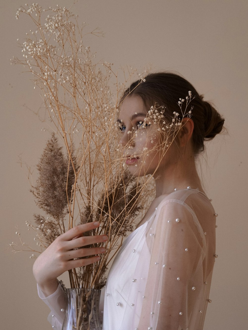 a woman holding a tree branch