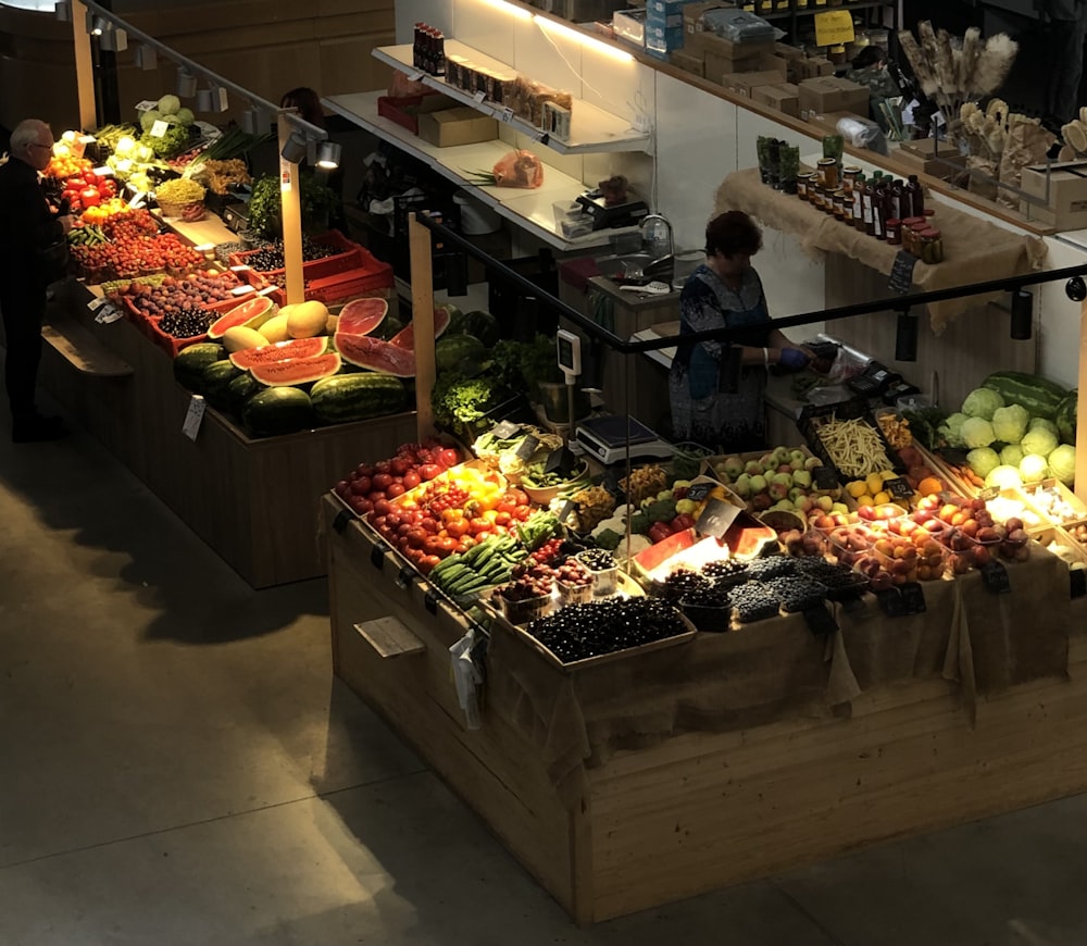 a fruit stand with fruits and vegetables