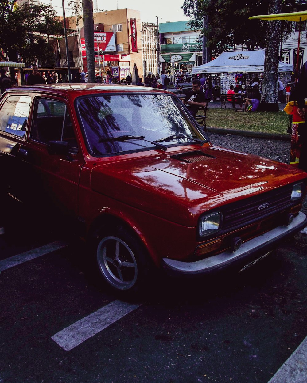 a red car parked on the side of a street