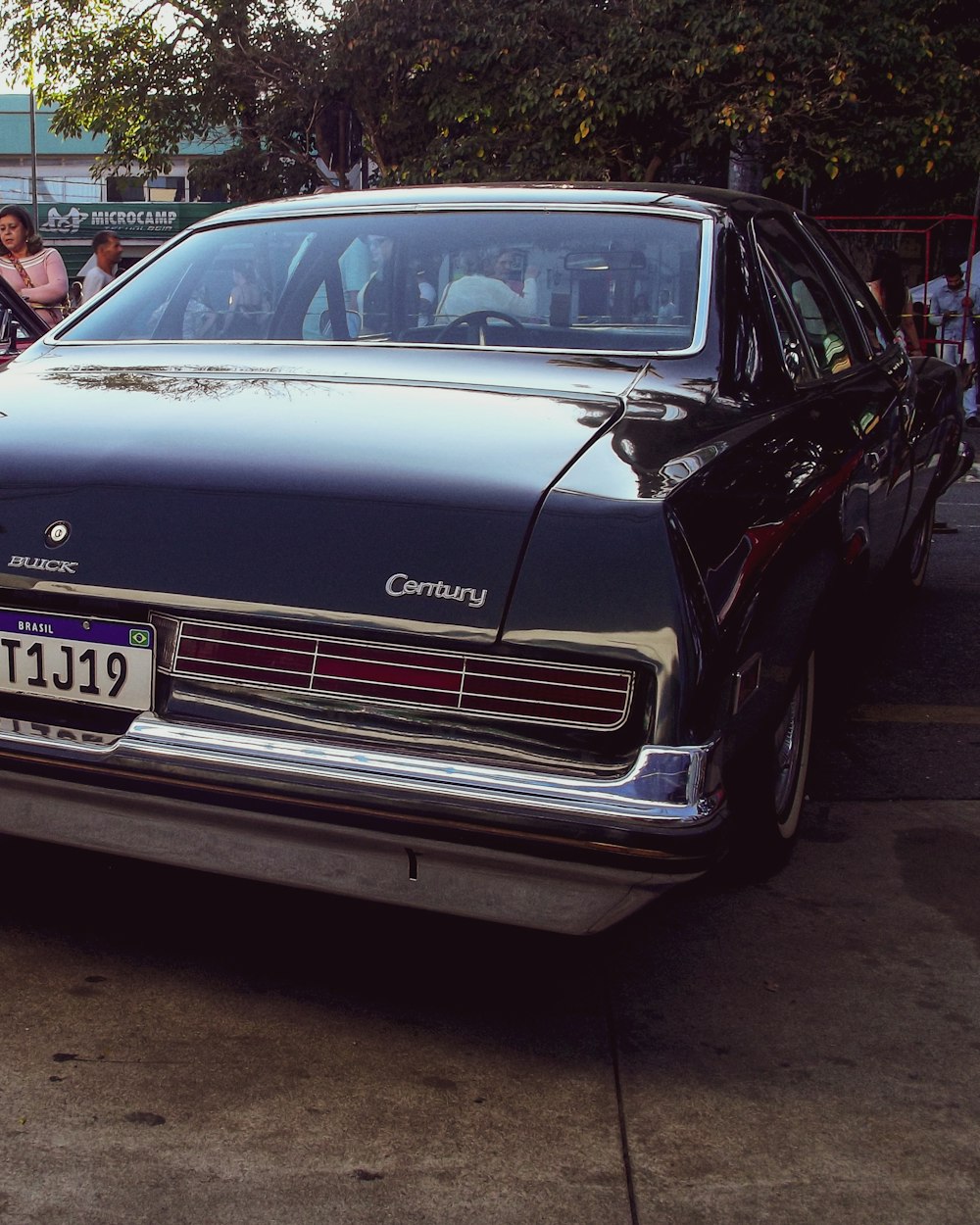 a black car parked on the side of the road