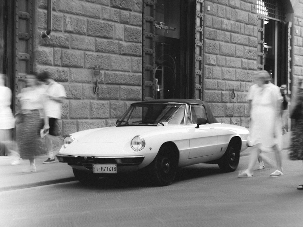 a white car parked on the side of a street