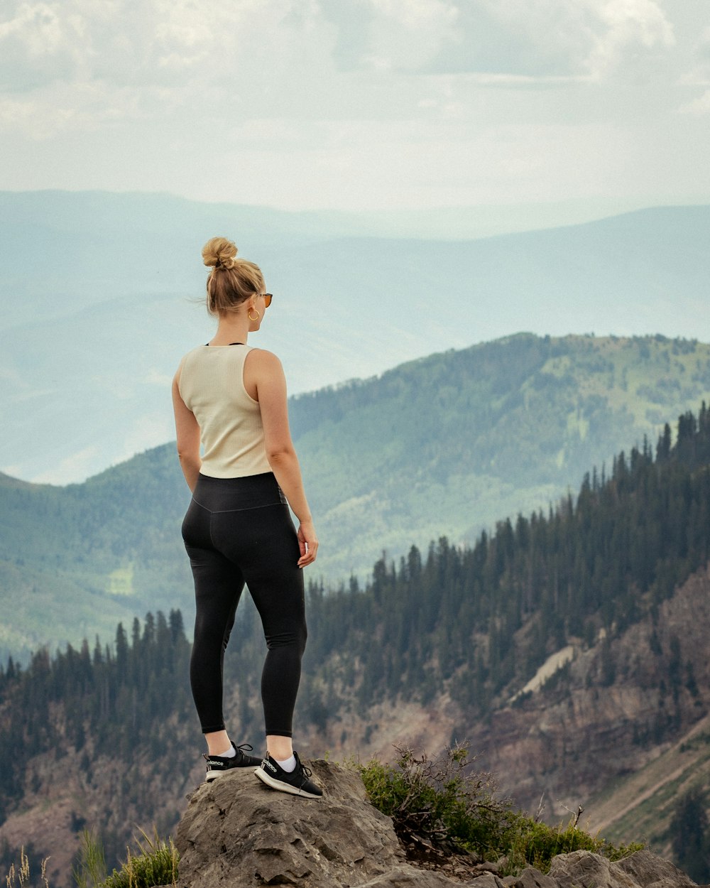 a man standing on a rock overlooking a valley