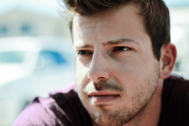 A close-up of the film’s lead actor looking thoughtfully into the distance in a sunlit valley