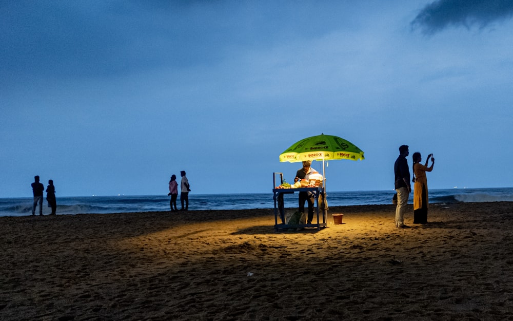 a group of people stand on a beach