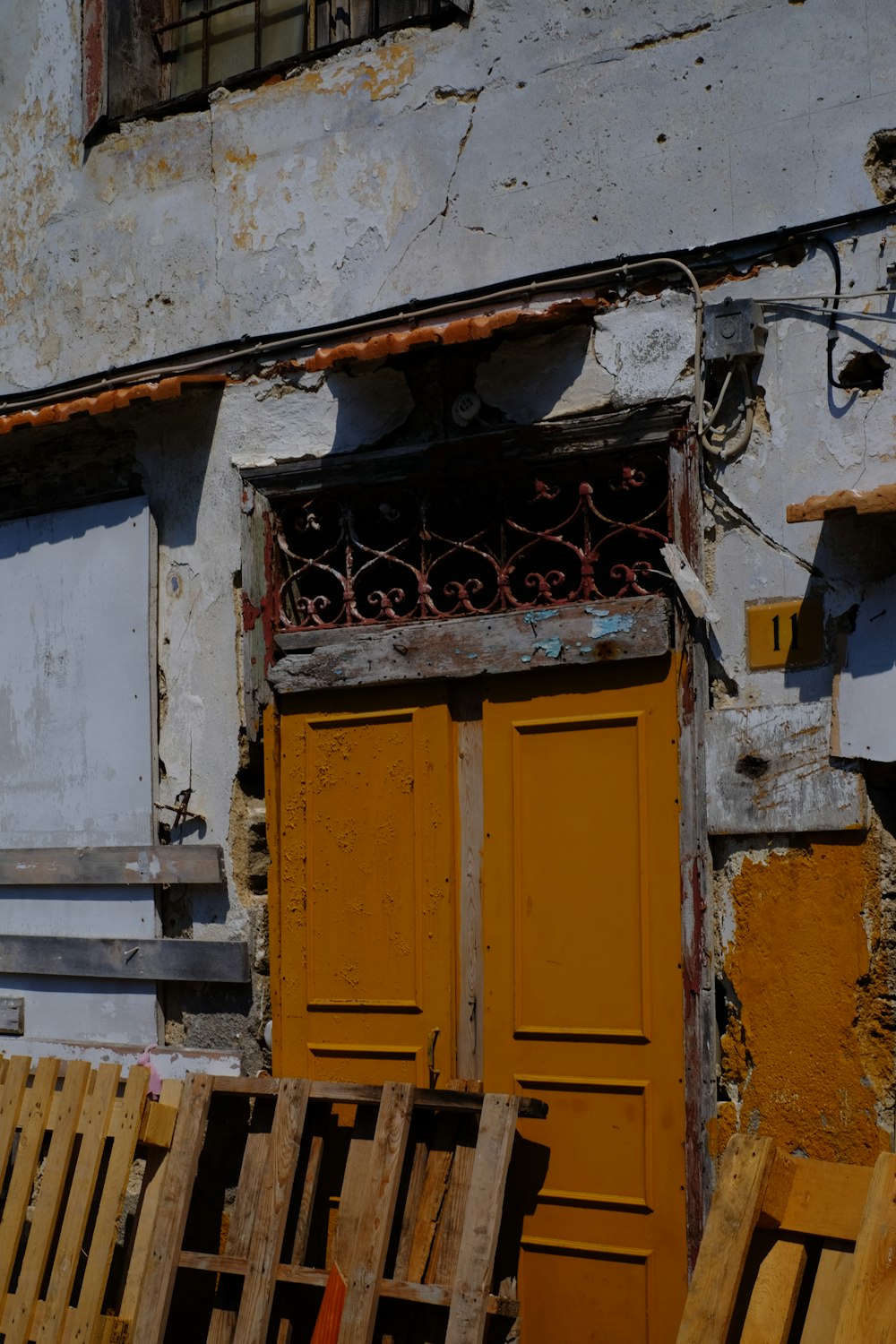 a yellow door and a wooden bench