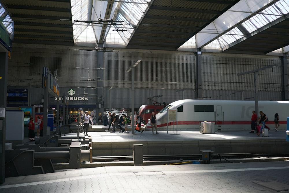 a train station with people waiting