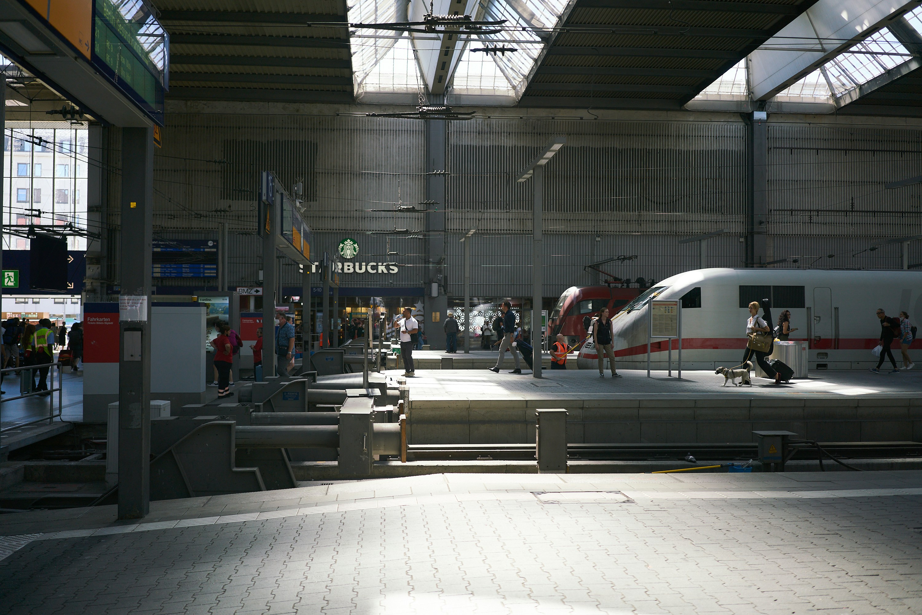 a train station with people and a train, High-speed train ICE at the railway station Hauptbahnhof waiting, summer travel. Platform