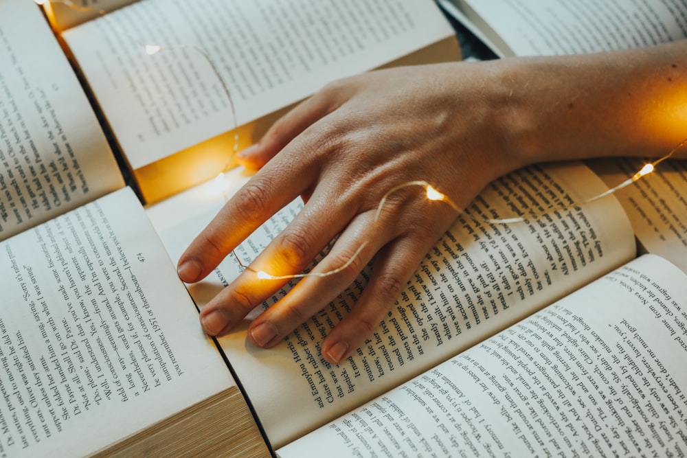 a hand on a book