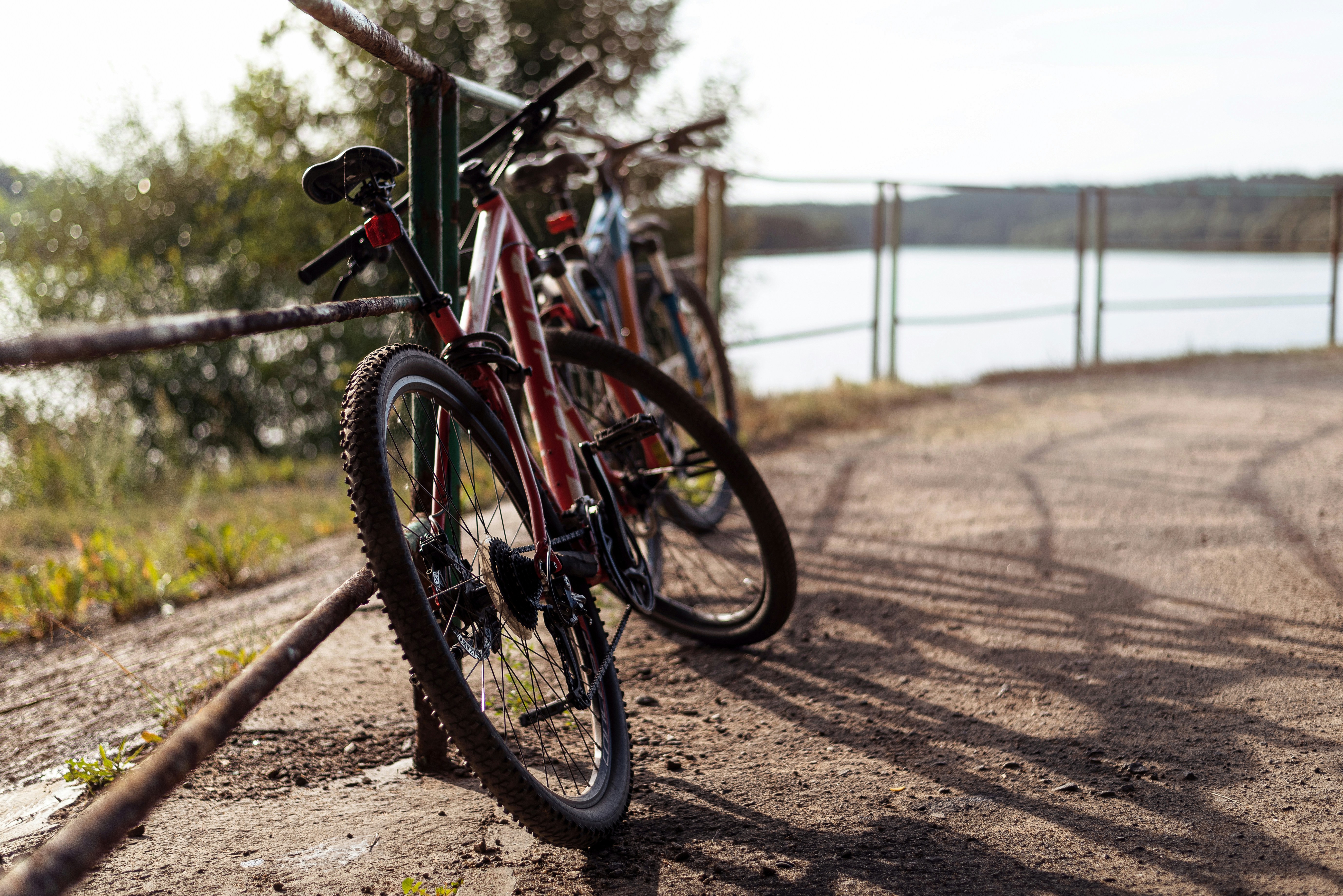 a bicycle parked on a dirt path