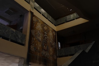 An elegant gobelin wall tapestry hanging in a softly lit room.