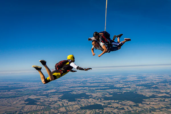 Skydivers in freefall above the clouds