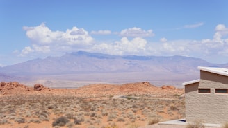 Modern desert home under construction with clear blue skies and rugged Arizona landscape.