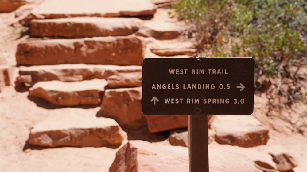 a sign in front of a pile of rocks