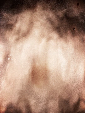 Charcoal-textured background with soft sand accents and a glowing button.