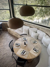 Dining area set for 50 guests with warm lighting and comfortable seating.