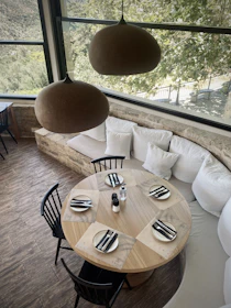 Dining area set for 50 guests with warm lighting and comfortable seating.