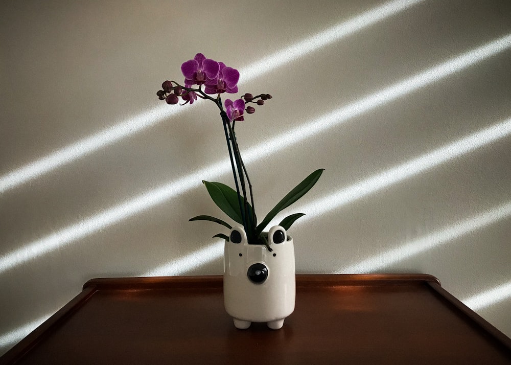 a vase with purple flowers