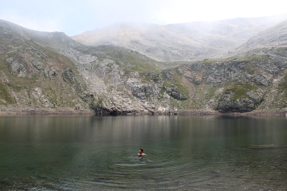 a person swimming in a lake