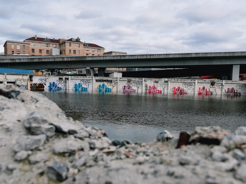 a bridge over a river with graffiti