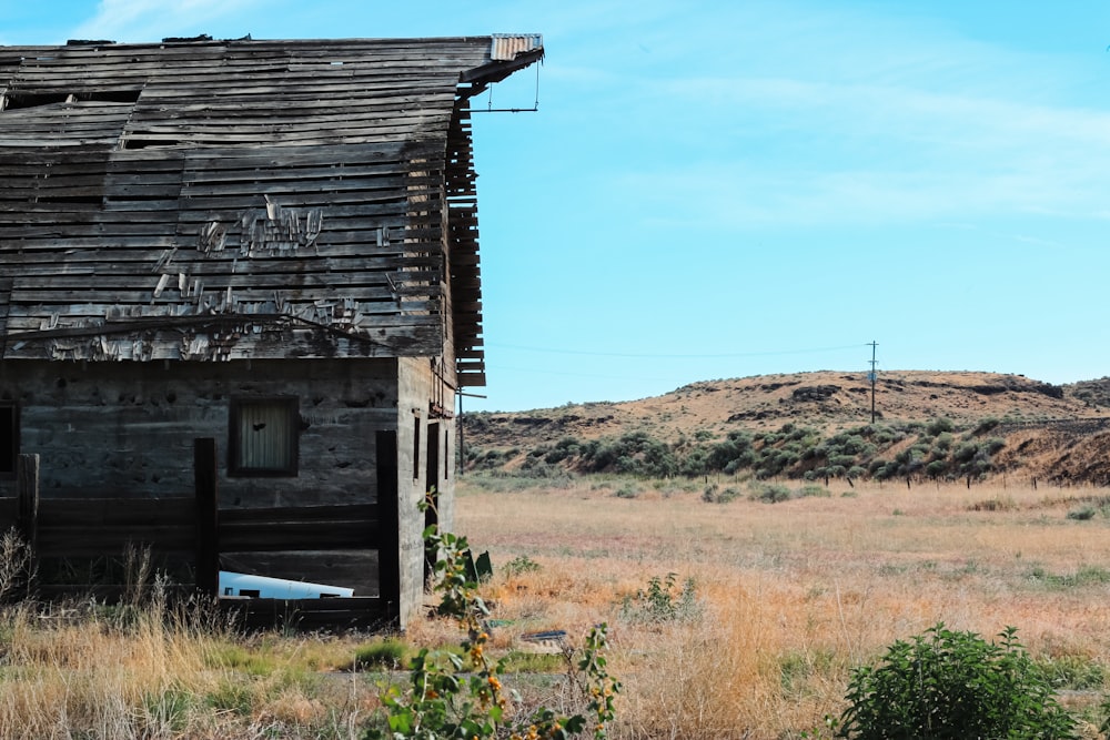 a wooden building in a field