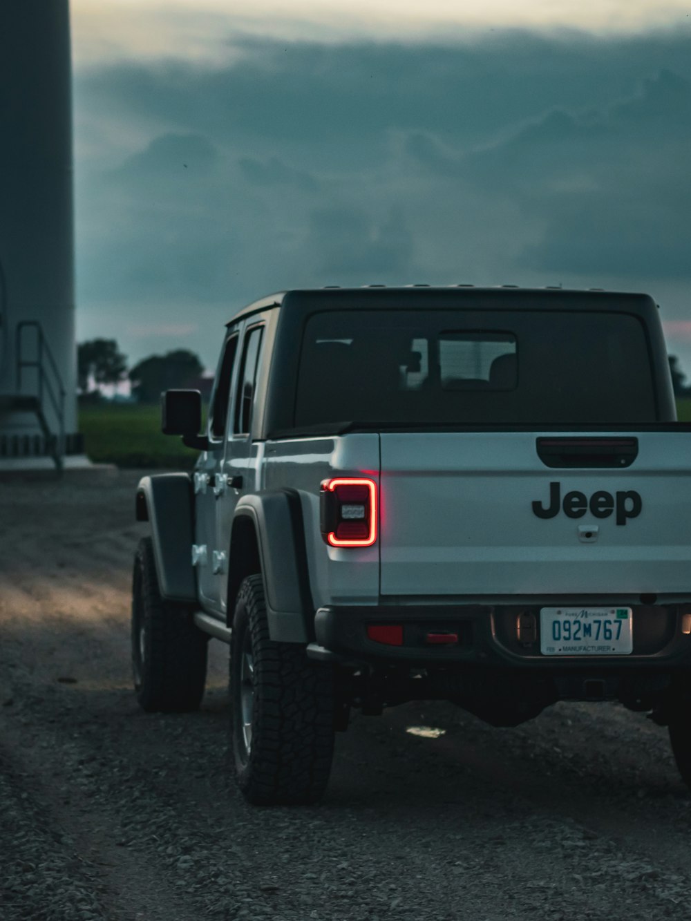 a white truck parked on gravel