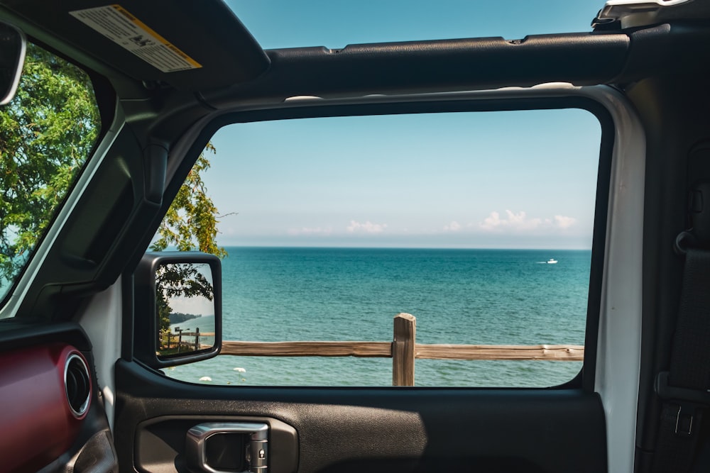 a view of the ocean from a car window