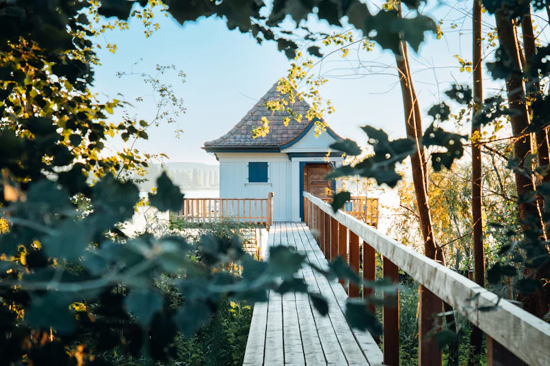 A wooden bridge leading to a house
