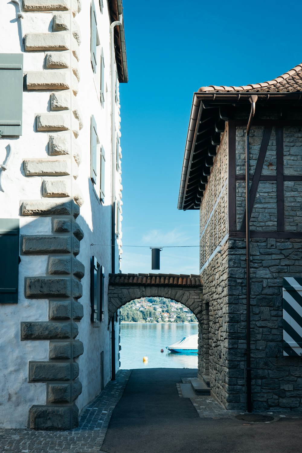 a stone walkway between buildings