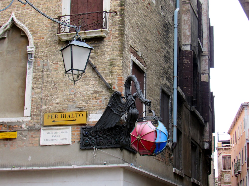 a statue of a person holding an umbrella on a sidewalk