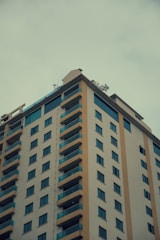 A modern residential building with large windows and balconies.