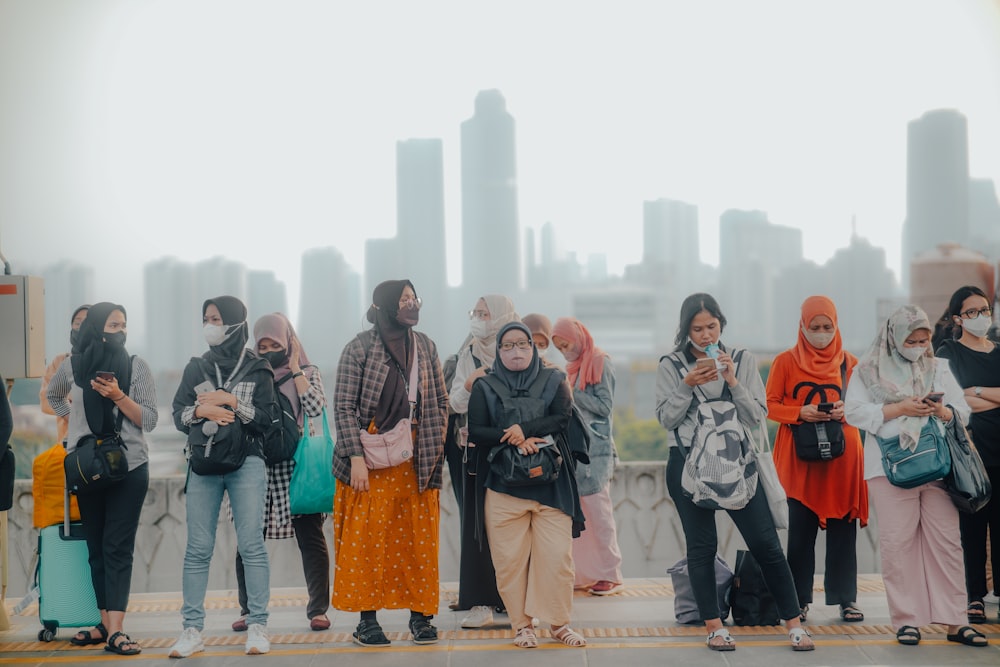 a group of people standing in front of a city skyline