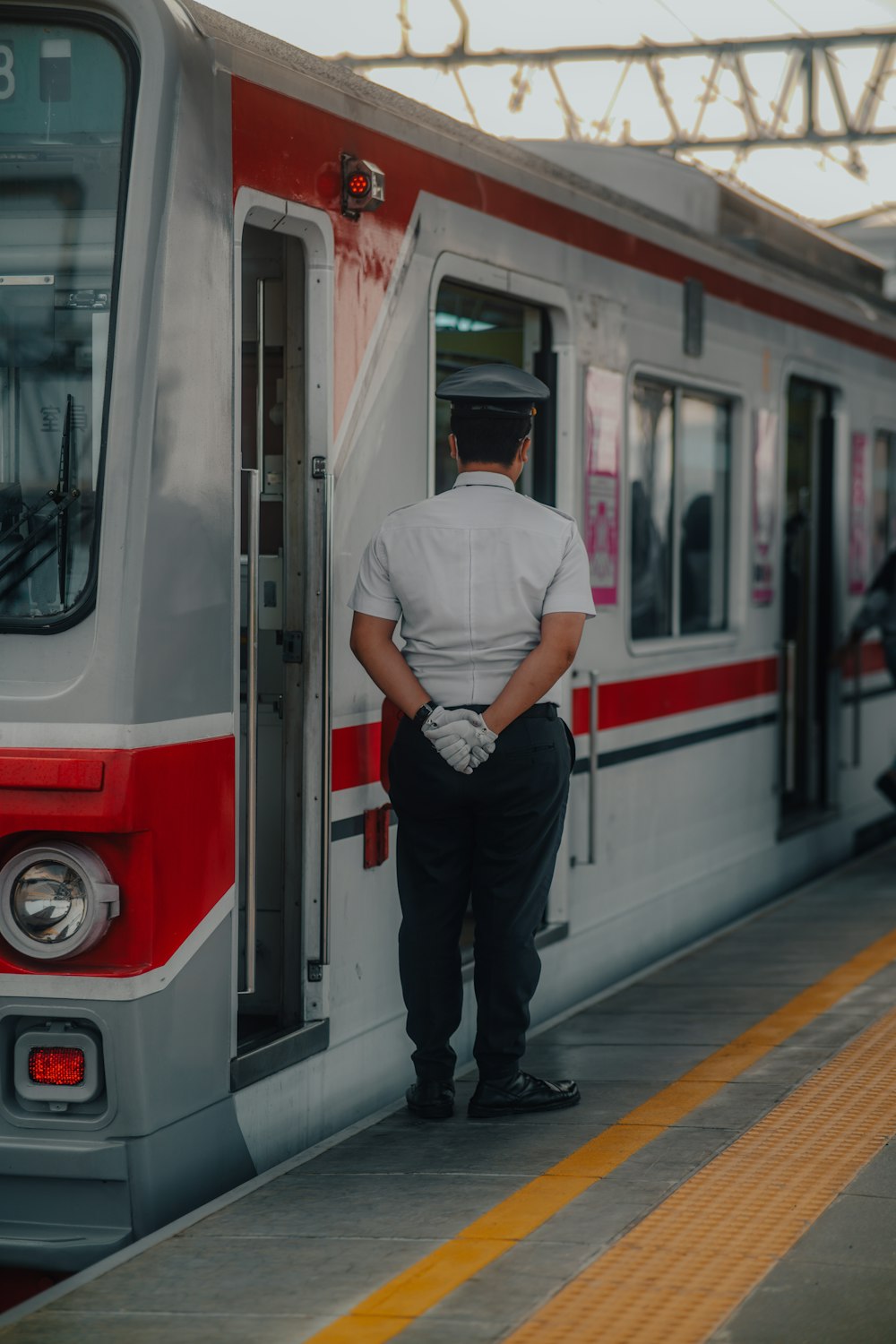 a man stands in the door of a train