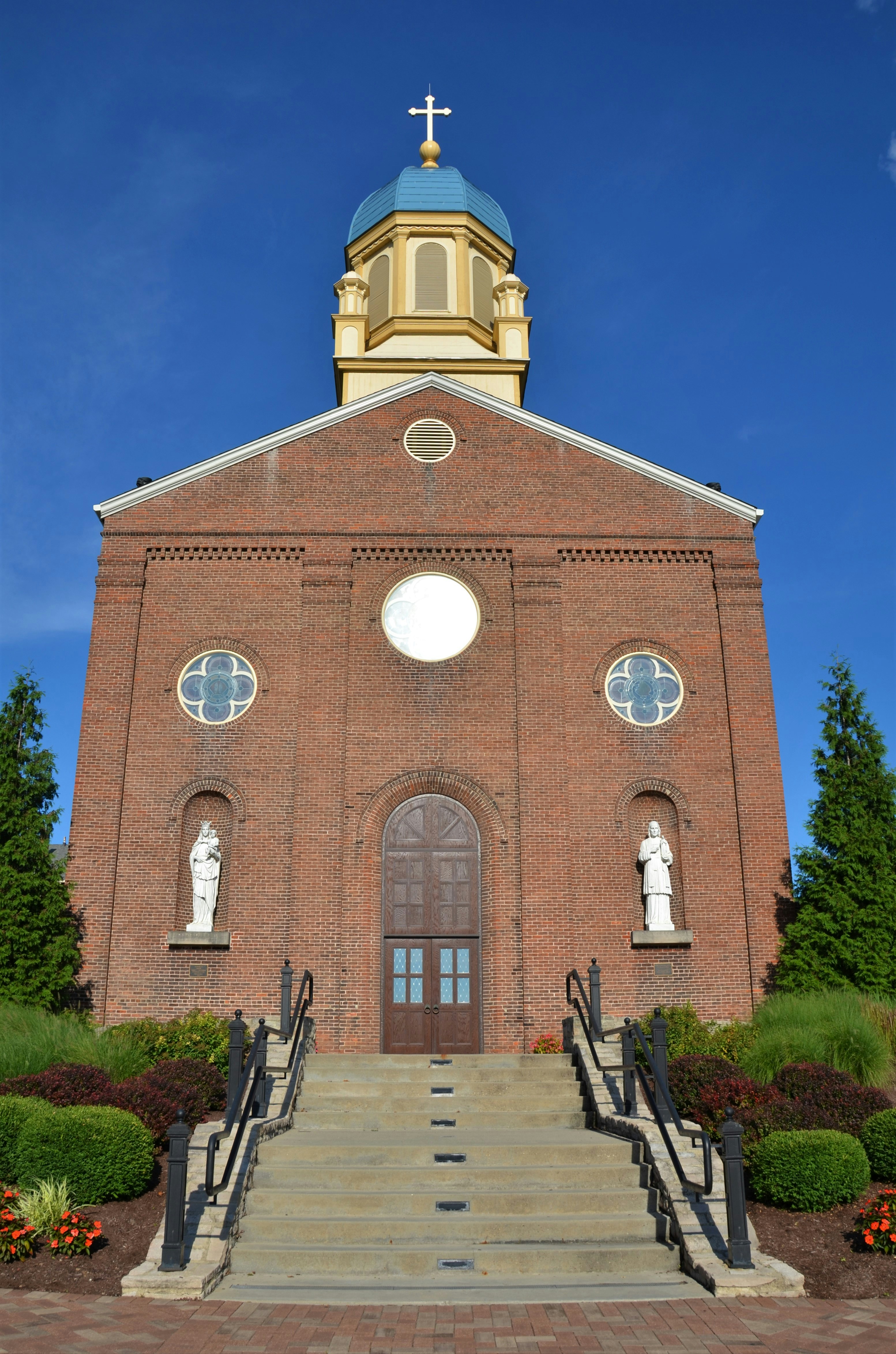 a brick building with a cross on top