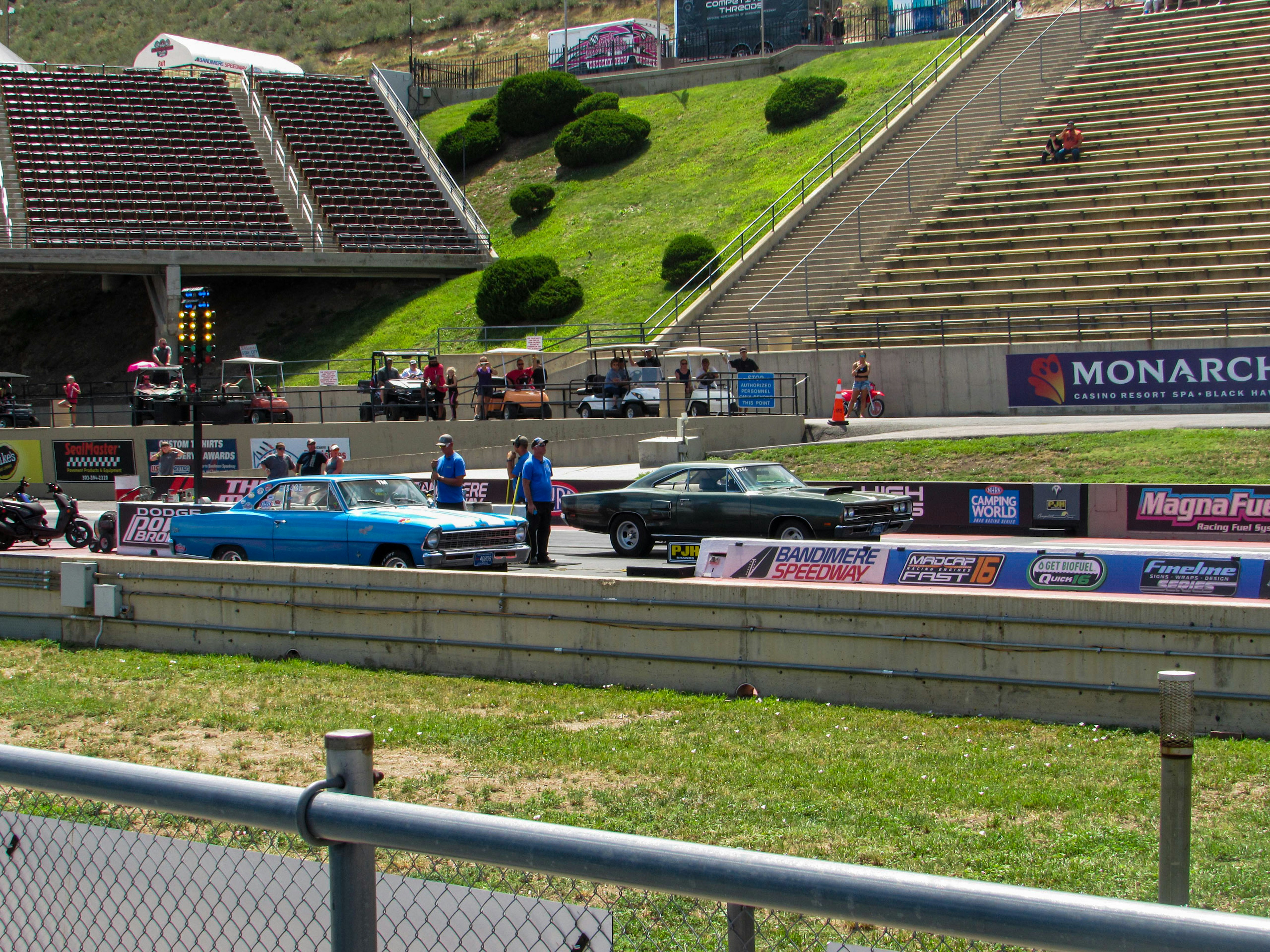 A group of cars on a race track photo – Free Person Image on Unsplash