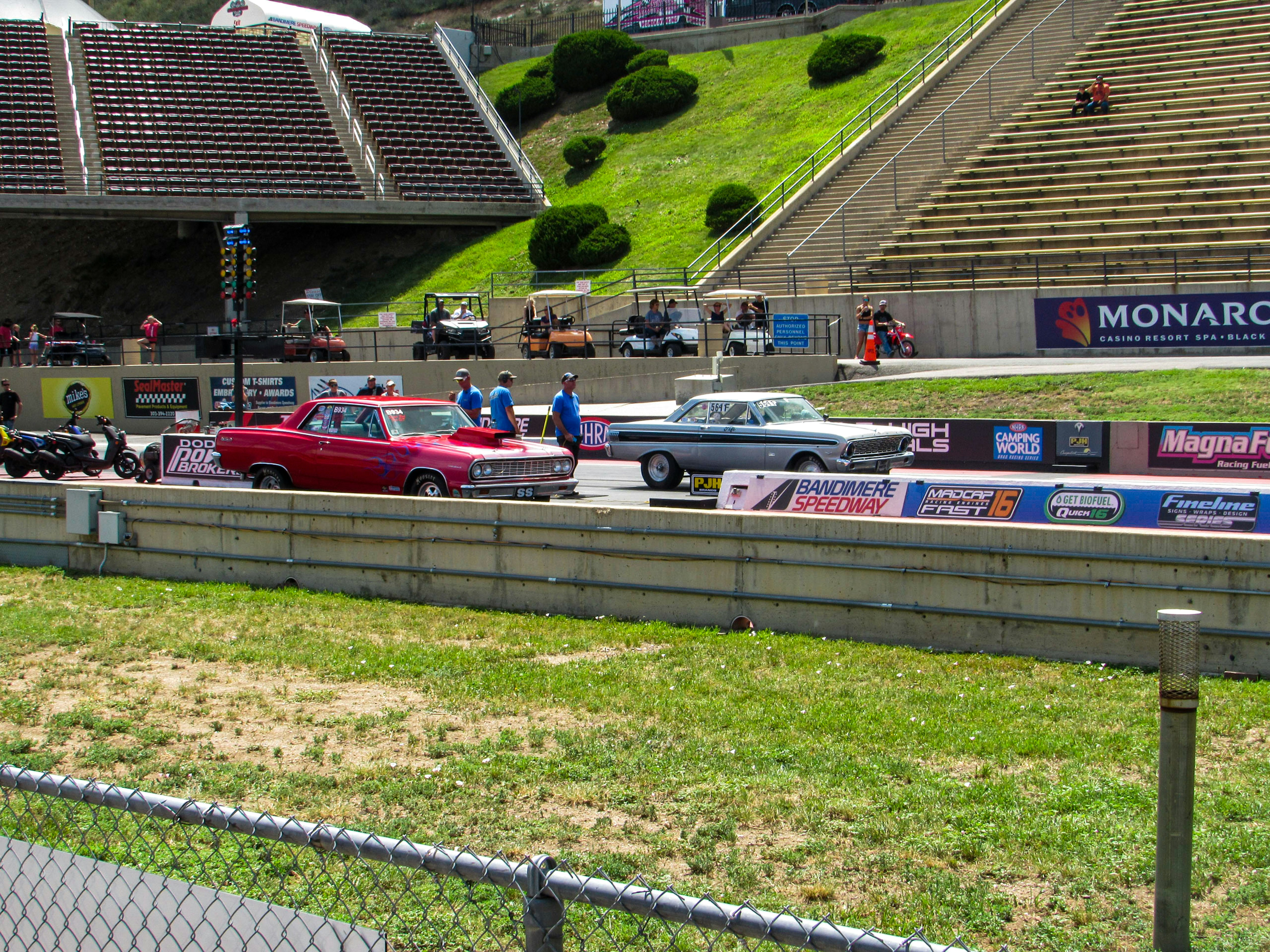 A group of cars on a race track photo – Free Person Image on Unsplash