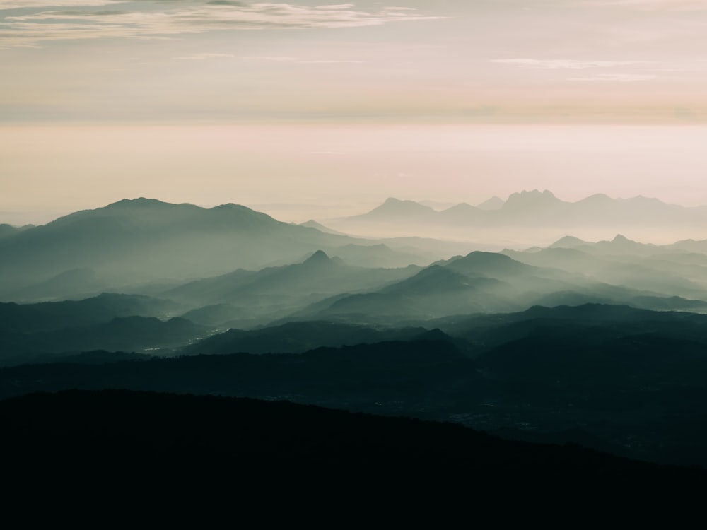 a landscape with hills and fog