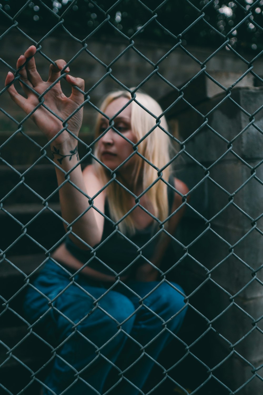 a woman behind a fence