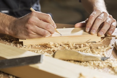 a person cutting a piece of wood