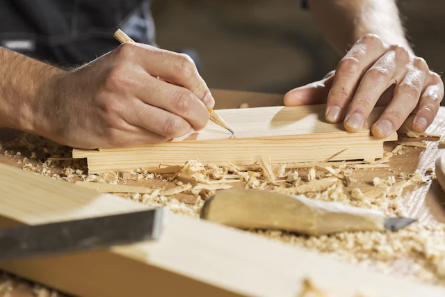 Carpenter cutting timber in a workshop