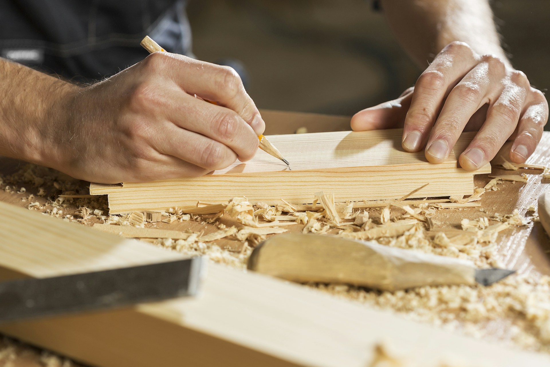 a person cutting a piece of wood