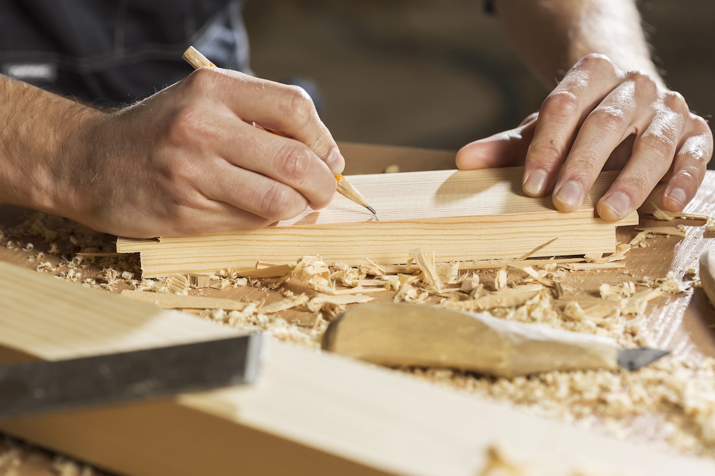 A craftsman working timber on a workbench