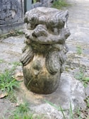 A weathered statue of a mythical creature standing guard in a forgotten temple.