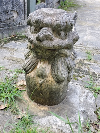 A weathered statue of a mythical creature standing guard in a forgotten temple.