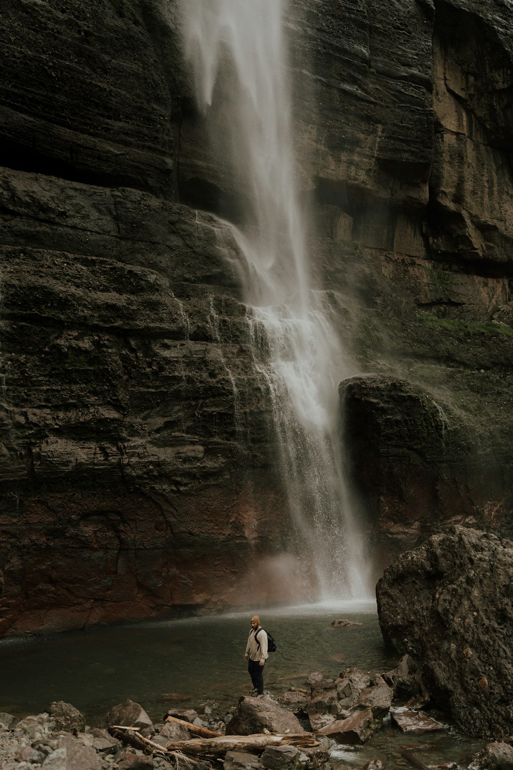 a person standing in front of a waterfall