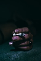 Close-up of hands holding a broken cigarette, emphasizing the decision to quit.