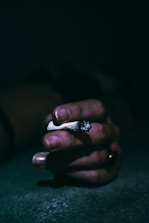 a person's hand with a ring on it