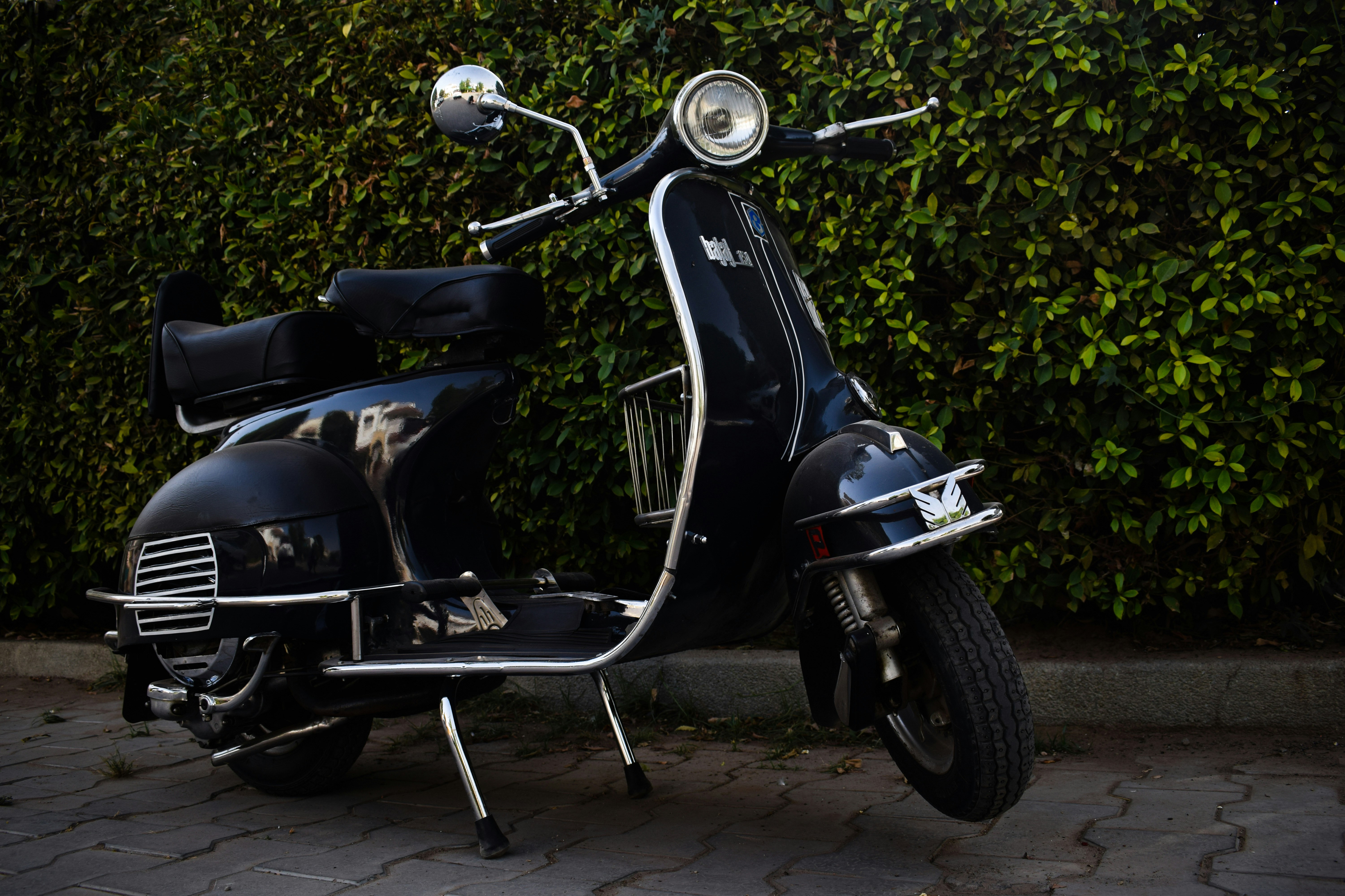 a black motorcycle parked on a sidewalk