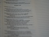 A close-up of a page from a book, specifically showing Psalm 135 with text focused on praise and worship. The text is clearly visible and legible, with a portion emphasized by slightly larger and bold font.