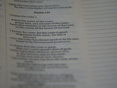 A close-up of a page from a book, specifically showing Psalm 135 with text focused on praise and worship. The text is clearly visible and legible, with a portion emphasized by slightly larger and bold font.