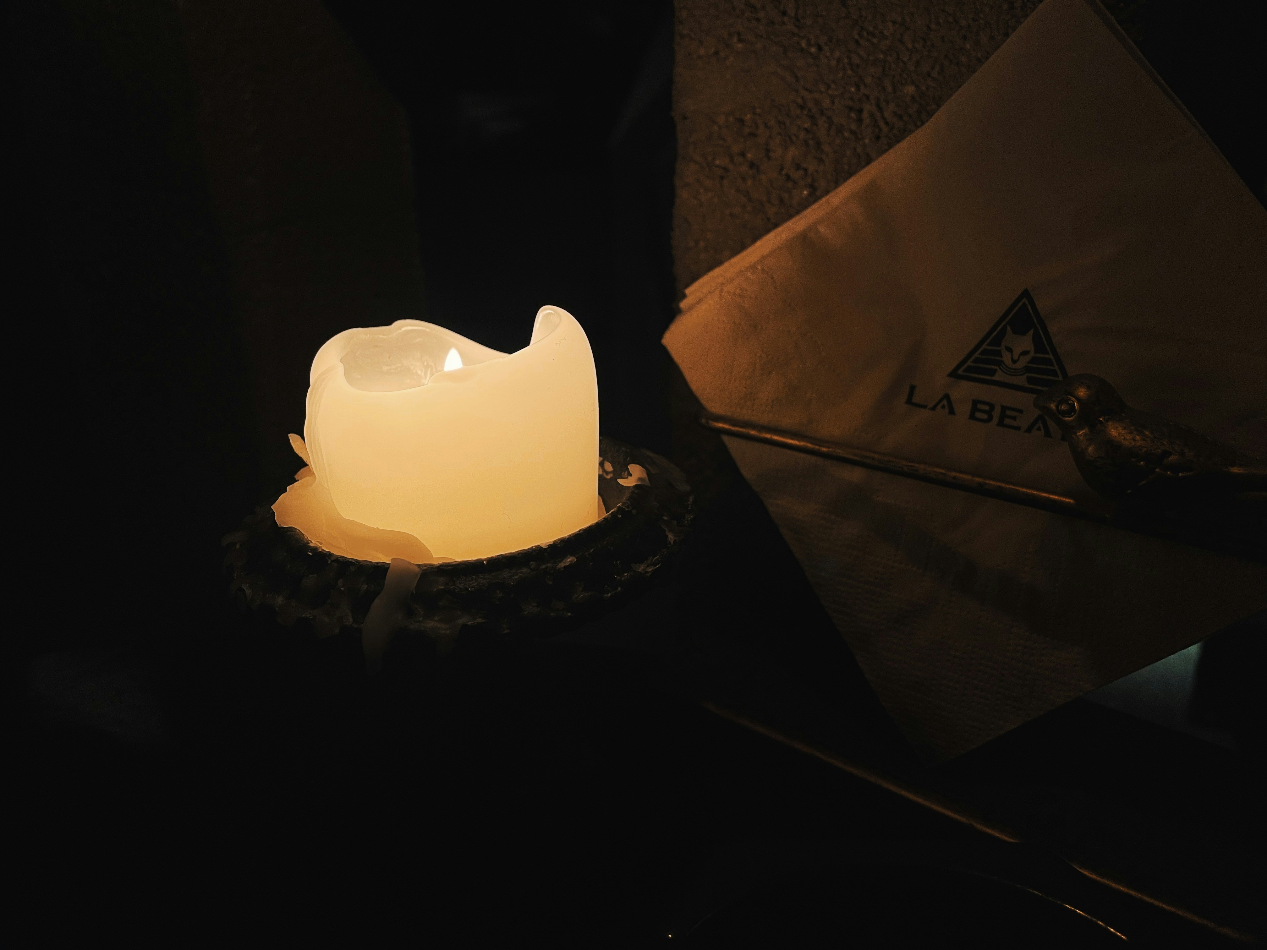 a candle on a table, 